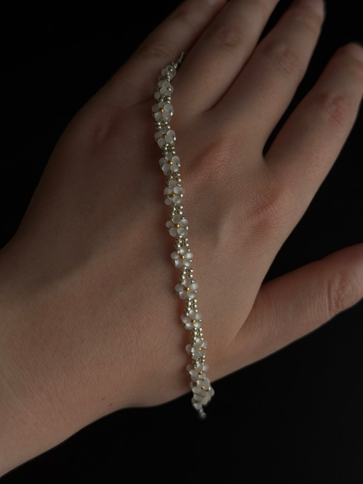 Daisy Bead Bracelet hand detail showing white seed bead flowers