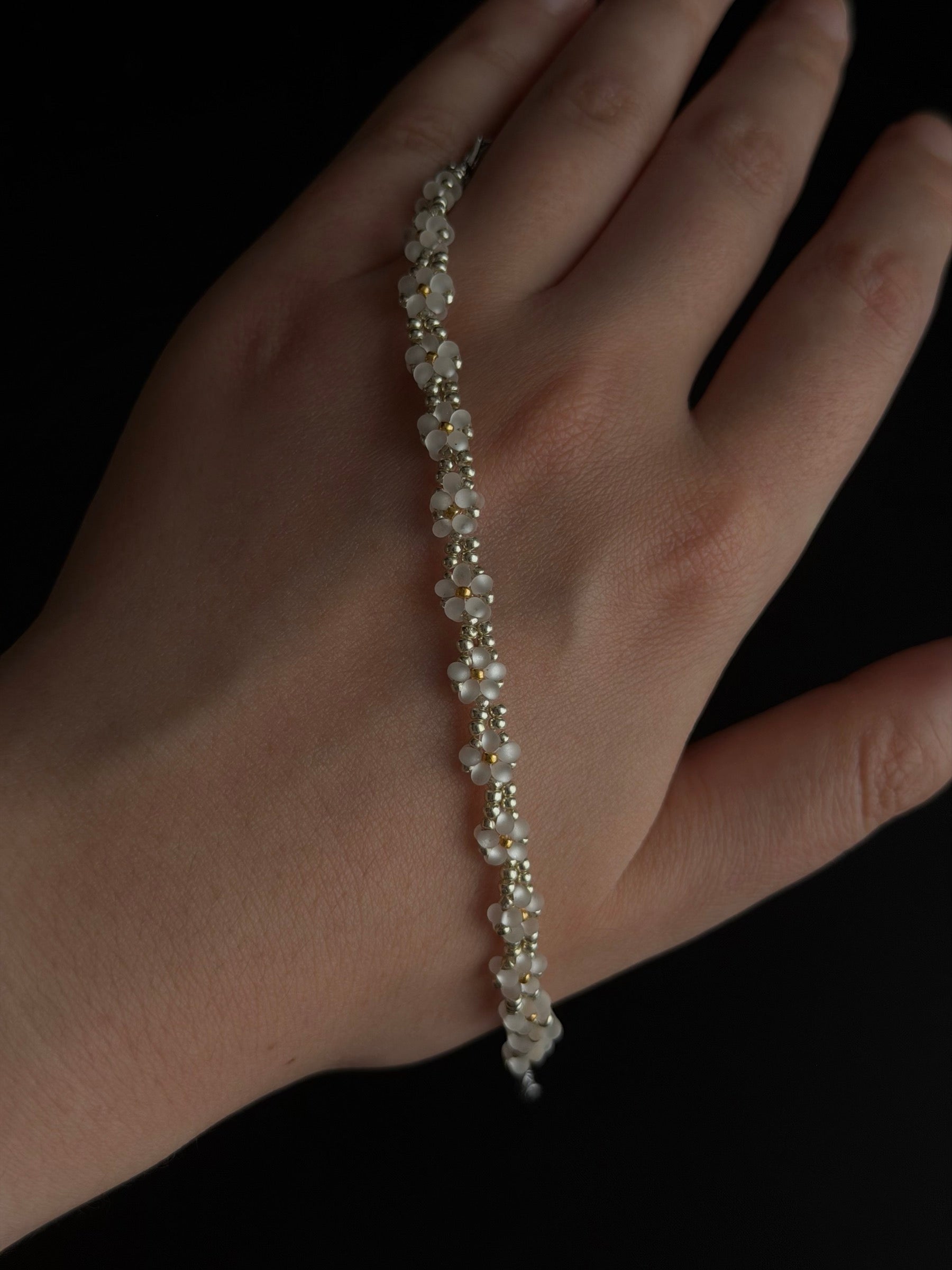 Daisy Bead Bracelet hand detail showing white seed bead flowers